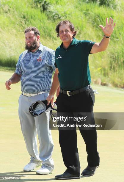 Andrew 'Beef' Johnston of England and Phil Mickelson of the United States acknowledge the crowd on the 18th green during the third round of the 2018...
