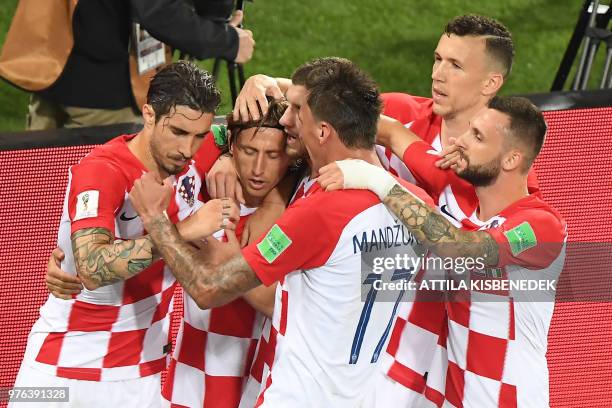 Croatia's midfielder Luka Modric celebrates with teammates after scoring a penalty during the Russia 2018 World Cup Group D football match between...