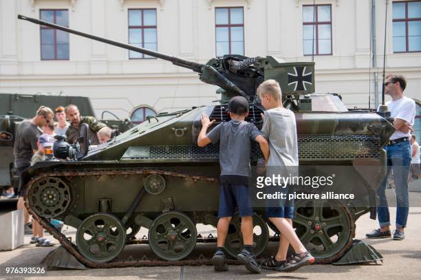 June 2018, Germany, Dresden: Two boys examine a weapon carrier of the model WIESEL 1 at the Museum of Military History on 'Bundeswehr Day'. Photo:...