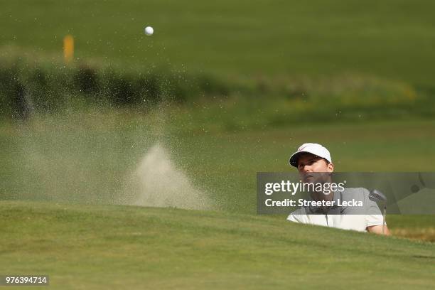 Russell Henley of the United States plays a shot from a bunker on the sixth hole during the third round of the 2018 U.S. Open at Shinnecock Hills...