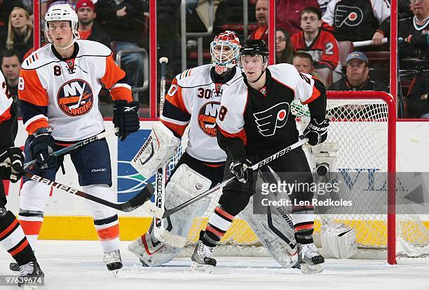 Claude Giroux of the Philadelphia Flyers battles with Bruno Gervais and Dwayne Roloson of the New York Islanders on March 9, 2010 at the Wachovia...