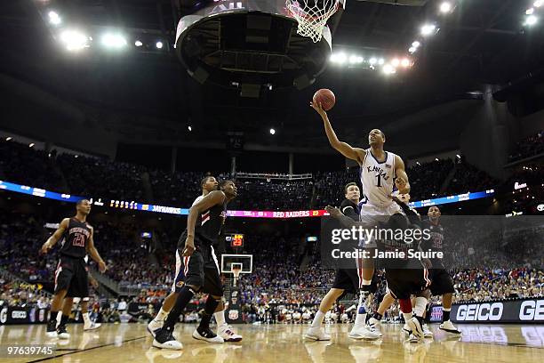 Xavier Henry of the Kansas Jayhawks goes up for a shot against Nick Okorie of the Texas Tech Red Raiders in the first half during the quarterfinals...