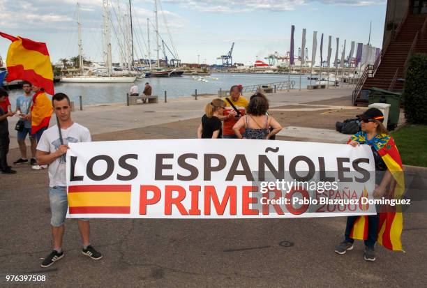 Far-right wing protesters hold Spanish flags and a banner reading 'Spanish people first' as they demonstrate against the arrival of migrants in the...