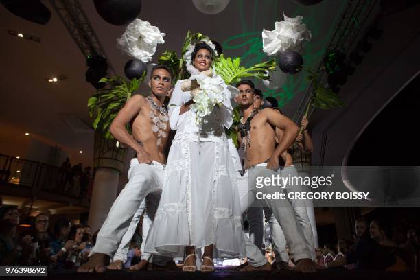 Models present creations during a models contest on the last day of the Tahiti Fashion Week on June 15, 2018 in Papeete.