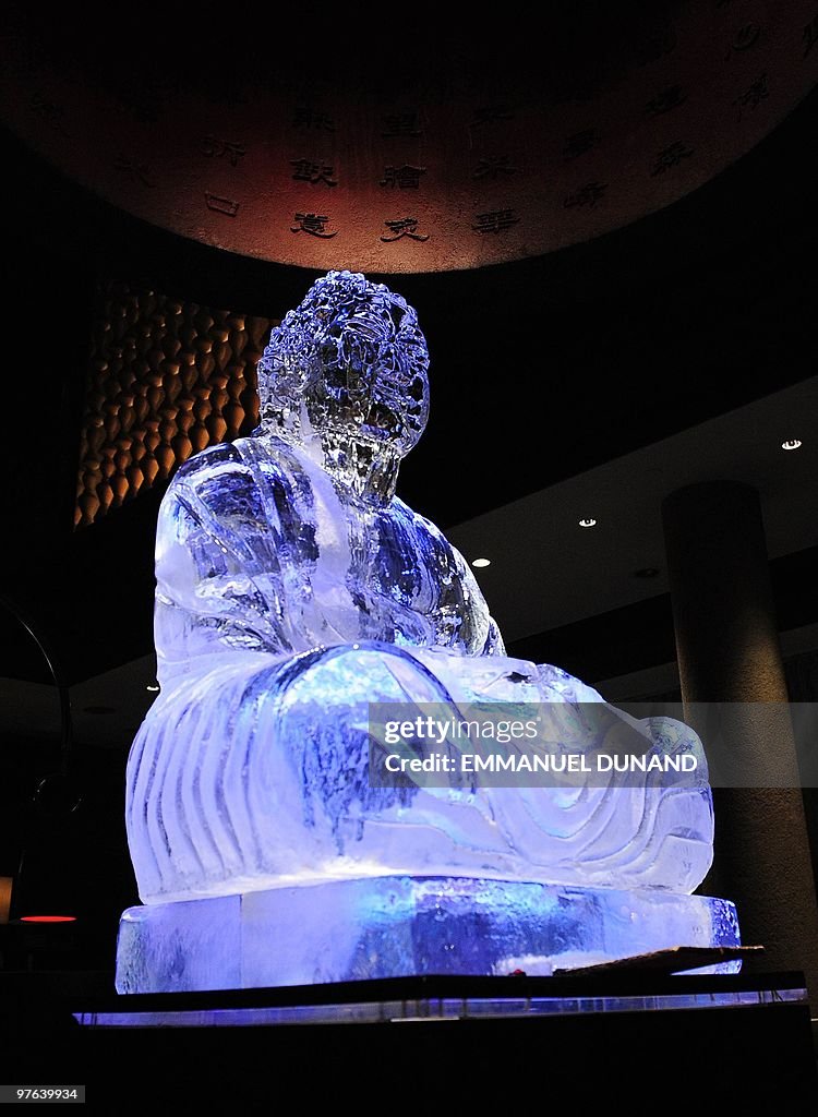 A Buddha statue carved in ice sits as th