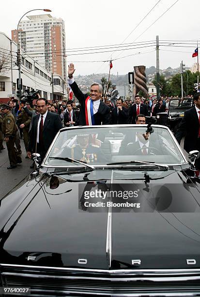Sebastian Pinera, president of Chile, waves to the crowd from his motorcade following his inuaguration at the National Congress in Valparaiso, Chile,...