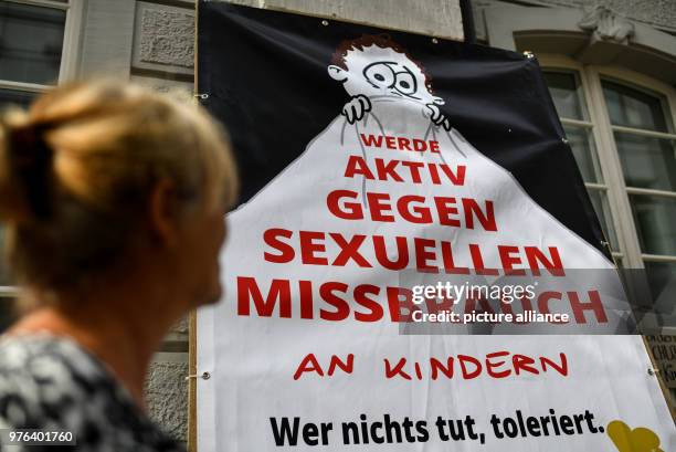 June 2018, Freiburg, Germany: Members of the initiative "Aktiv gegen Missbrauch" hold up a banner in front of the district court, calling for...