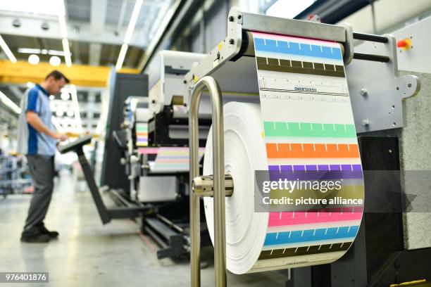 June 2018, Wiesloch, Germany: An employee stands at a printing machine, type "Gallus Labelfire", a label printer, at the factory of the Heidelberger...