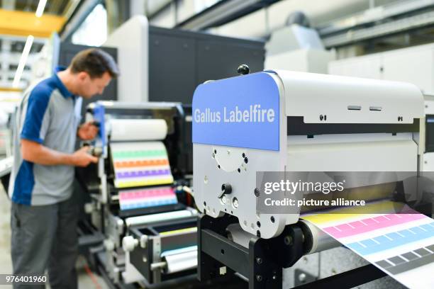 June 2018, Wiesloch, Germany: An employee stands at a printing machine, type "Gallus Labelfire" at the factory of the Heidelberger Druckmaschinen AG....
