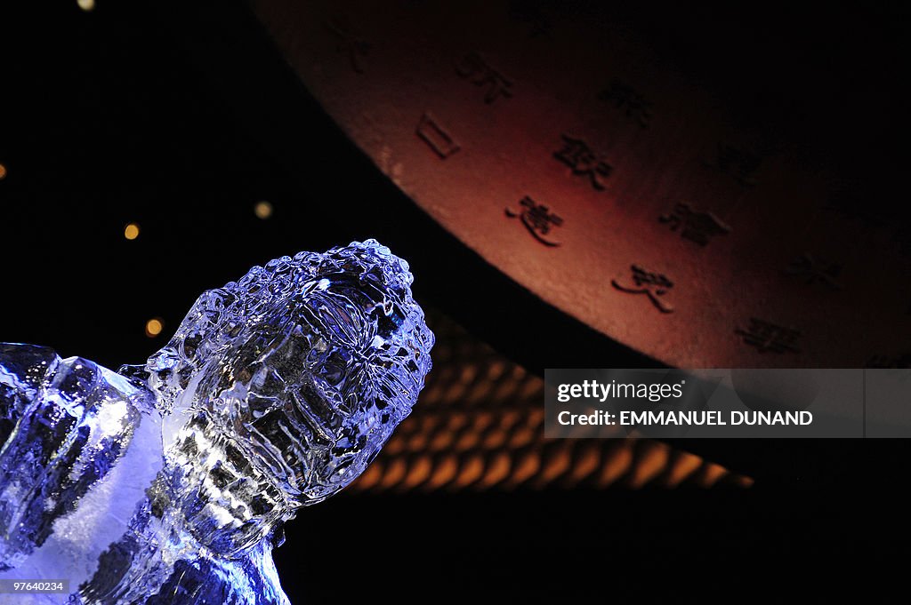 A Buddha statue carved in ice sits as th