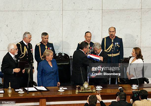 Sebastian Pinera, the new president of Chile, third from right, receives the presidential sash as Michelle Bachelet, the outgoing president, center...