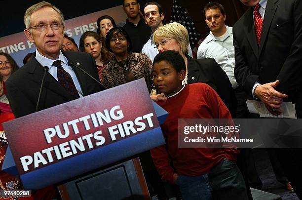 Senate Majority Leader Harry Reid puts his hand on the shoulder of 11 year old Marcelas Owens during a national health care event with U.S. Sen....