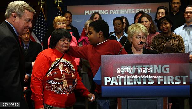 Marcelas Owens hugs his grandmother, Gina Owens before speaking at a national health care event with U.S. Sen. Patty Murray and Sen. Richard Durbin...