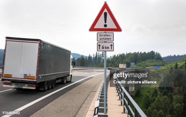 June 2018, Suhl, Germany: Vehicles drive by new cracks in the pavement of the motorway A73. The 16,5 kilometre long section between Suhl and...