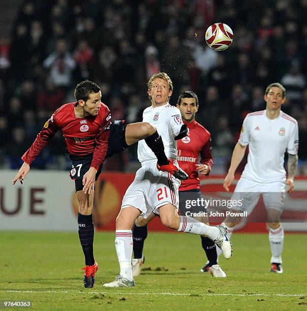 Lucas Leiva of Liverpool goes up with Yohan Cabaye of Lille during the UEFA Europa League last 16, first leg match between Lille and Liverpool at...