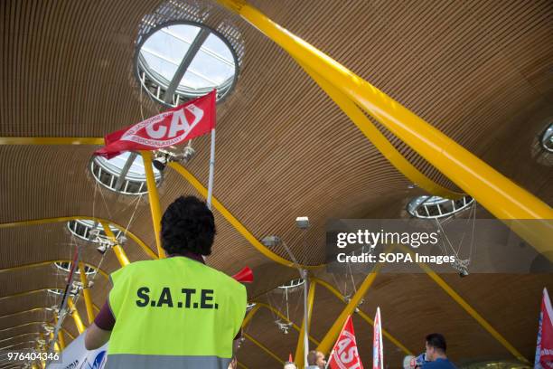 Worker holding a flag of the union AST. Barajas Airport workers who supervise the automated luggages system went on strike because the AENA didnt...