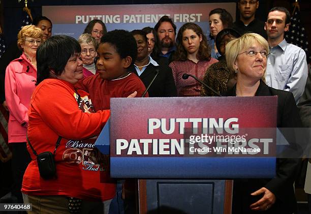 Marcelas Owens hugs his grandmother, Gina Owens before speaking at a national health care event with U.S. Sen. Patty Murray at the U.S. Capitol March...