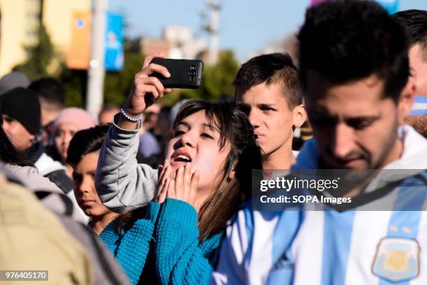 Fans seen in the square watching the large TV during the football game. Thousands of football fans took to the main square in Buenos Aires to see the...