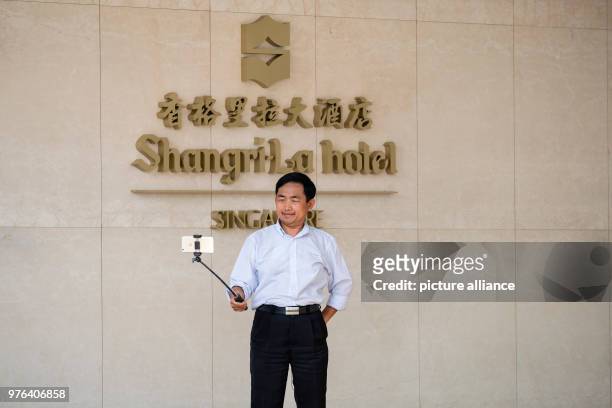 June 2018, Singapore, Singapore: A man takes a selfie outside the Shangri-La-Hotel, where US President Trump is staying. The summit meeting of US...