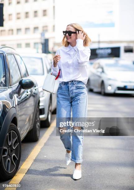 Candela Novembre wearing ripped denim jeans, white button shirt, white bucket bag is seen outside Marni during Milan Men's Fashion Week Spring/Summer...