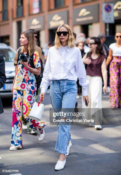 Candela Novembre wearing ripped denim jeans, white button shirt, white bucket bag is seen outside Marni during Milan Men's Fashion Week Spring/Summer...