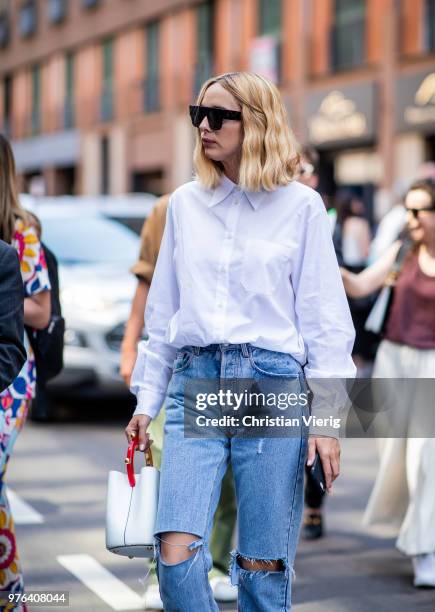 Candela Novembre wearing ripped denim jeans, white button shirt, white bucket bag is seen outside Marni during Milan Men's Fashion Week Spring/Summer...