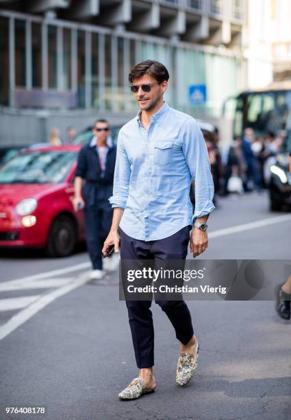 Johannes Huebl wearing navy pants, blue button shirt is seen outside Marni during Milan Men's Fashion Week Spring/Summer 2019 on June 16, 2018 in...