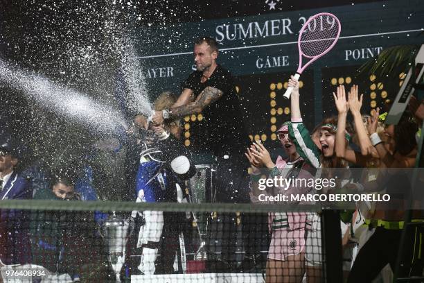 Personnality and model Paris Hilton and German fashion designer Philipp Plein spray champagne as they acknowledge the audience at the end of the show...