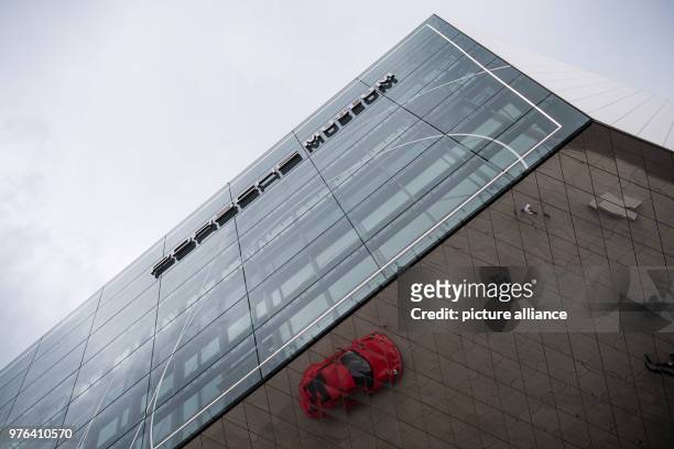 June 2018, Germany, Stuttgart: A red Porsche 911 is refelcted in the mirrored ceiling of the Porsche Museum during the celebration '70 years Porsche...