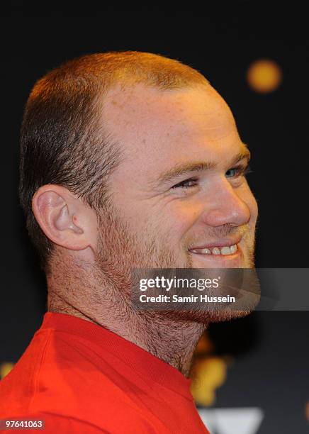 Wayne Rooney looks on after posing with the authentic FIFA World Cup Trophy as part of the FIFA World Cup Trophy Tour on March 11, 2010 at Earls...