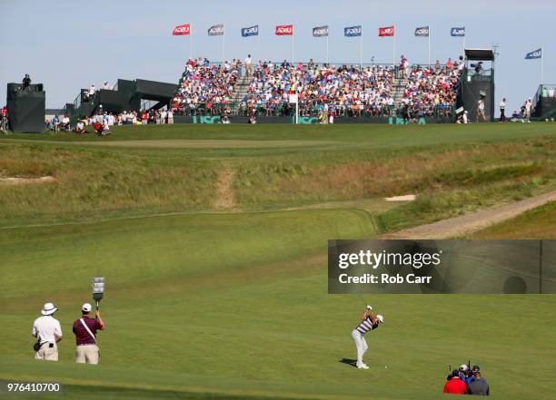 Dustin Johnson of the United States plays his second shot on the ninth green during the third round of the 2018 U.S. Open at Shinnecock Hills Golf...