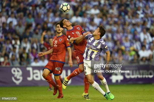 Jaime Mata of Real Valladolid competes for the ball with Dani Calvo of Club Deportivo Numancia during the La Liga 123 play off match between Real...