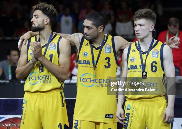 Joshiko Saibou, Peyton Siva and Bennet Hundt of Alba Berlin are pictured after loosing the fifth and final play-off game of the German Basketball...