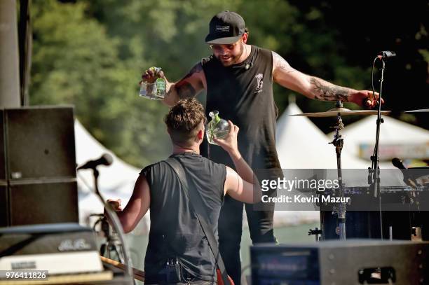 Mike Kerr and Ben Thatcher of Royal Blood drink tequila as they perform on the Firefly Stage during the 2018 Firefly Music Festival on June 16, 2018...