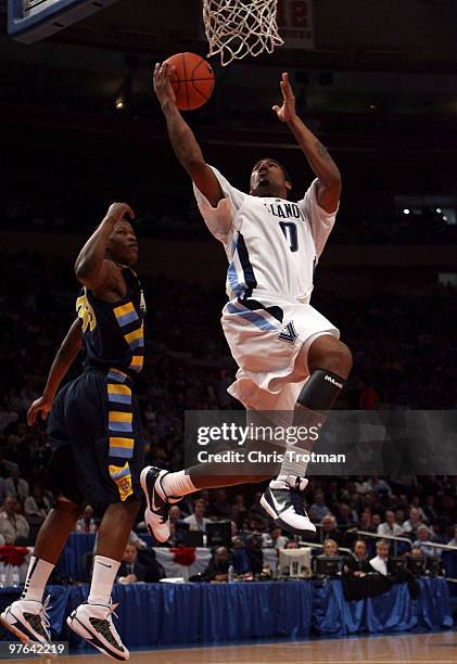 Antonio Pena of the Villanova Wildcats goes to the hoop against Jimmy Butler of the Marquette Golden Eagles during the quarterfinal of the 2010 NCAA...