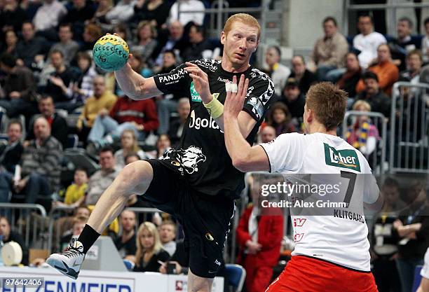 Karol Bielecki of Rhein-Neckar Loewen is challenged by Thomas Klitgaard of Melsungen during the Toyota Handball Bundesliga match between Rhein-Neckar...