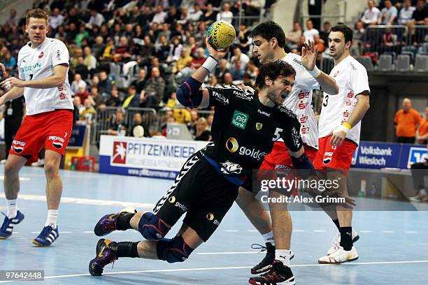 Carlos Prieto of Rhein-Neckar Loewen is challenged by Nenad Vuckovic of Melsungen during the Toyota Handball Bundesliga match between Rhein-Neckar...