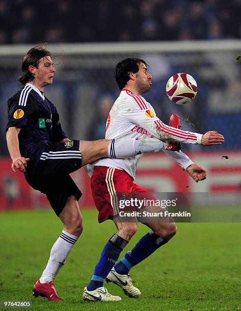 Ruud van Nistelrooy of Hamburg is challenged by Guillaume Gillet of Anderlecht during the UEFA Europa League round of 16 first leg match between...