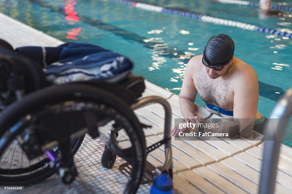 Adaptive athlete prepares to swim in a pool