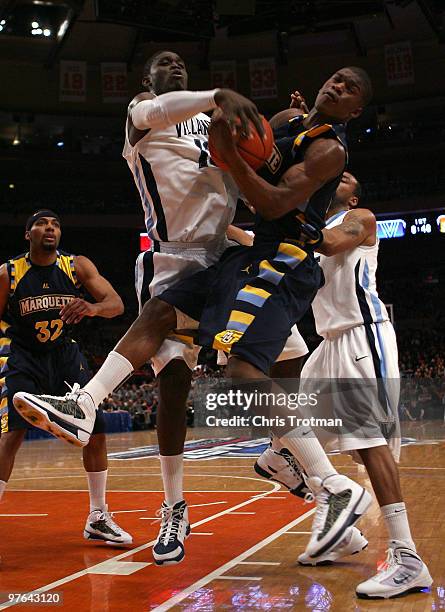 Jimmy Butler of the Marquette Golden Eagles fights for a ball with Mouphtaou Yarou of the Villanova Wildcats during the quarterfinal of the 2010 NCAA...