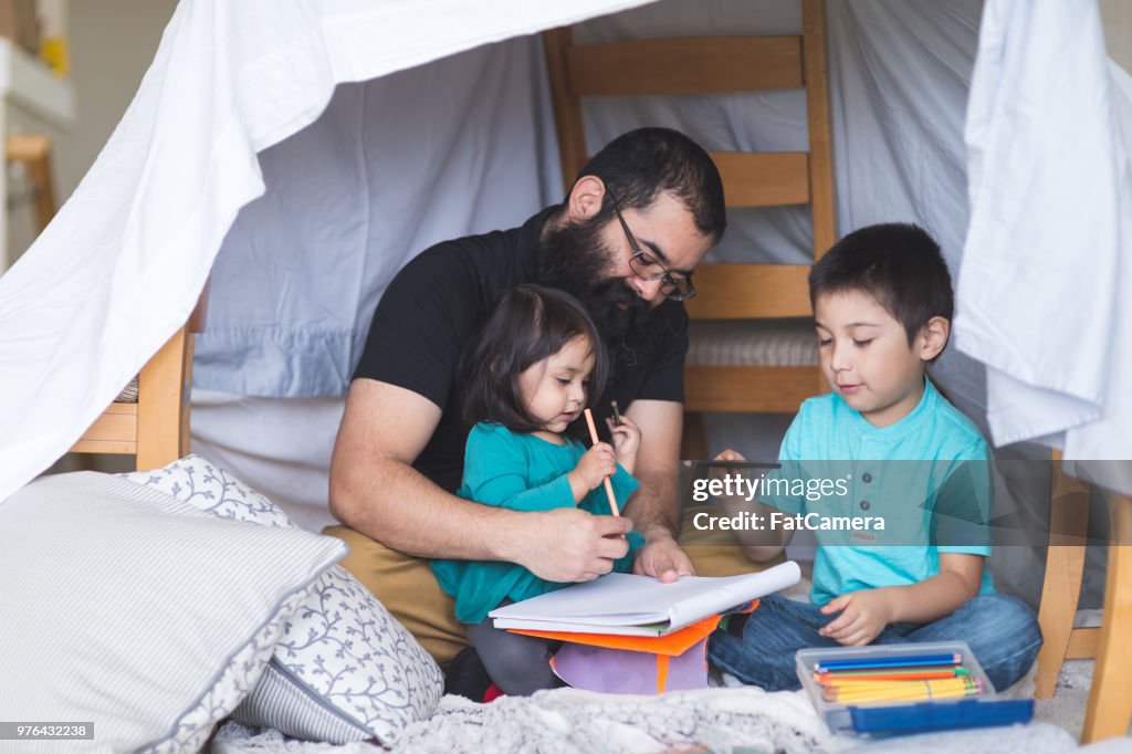 Native American Dad Does Art with His Young Children Under a Makeshift Fort in the Living Room