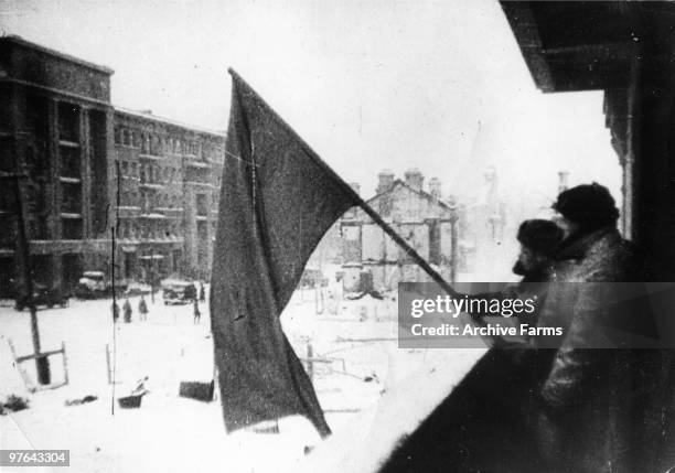 The red banner of the Soviet Army is hoisted up in a recaptured part of Stalingrad, as the German Sixth Army is beaten, 1943.