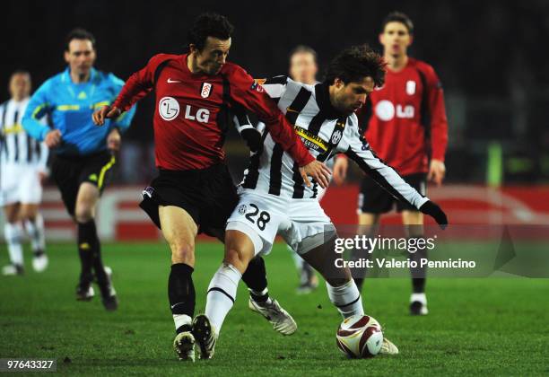 Ribas Da Cunha Diego of Juventus FC battles for the ball with Simon Davies of Fulham FC during the UEFA Europa League last 16, first leg match...