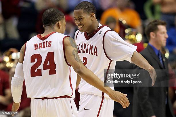 Mikhail Torrance and Charvez Davis of the Alabama Crimson Tide celebrate their 68-63 win against the South Carolina Gamecocks during the first round...