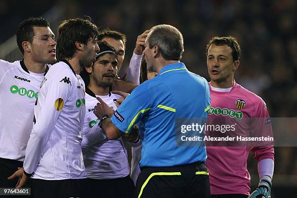 Referee Martin Atkinson talks to Valencias' players during the UEFA Europa League round of 16 first leg match between Valencia and SV Werder Bremen...