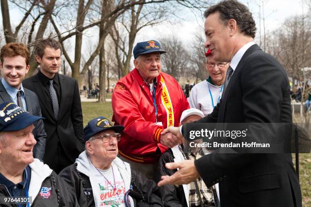 Actor Tom Hanks talks with veterans after a World War II Memorial ceremony to pay tribute to World War II veterans of the Pacific on March 11, 2010...