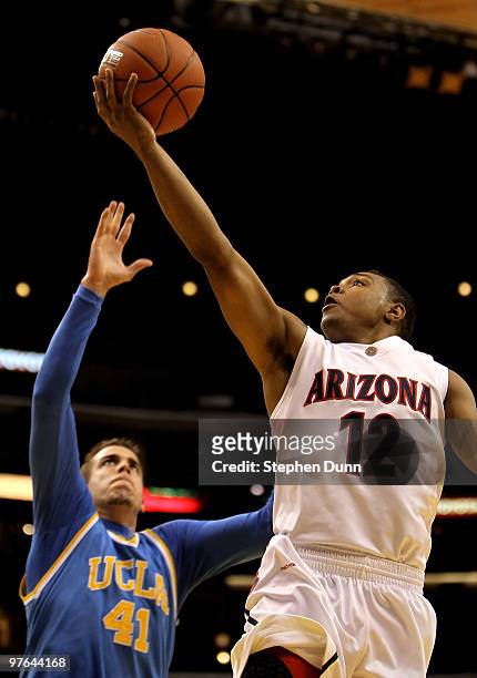 Lamont Jones of of the Arizona Wildcats shoots over Nikola Dragovic of the UCLA Bruins during the quarterfinals of the Pac-10 Basketball Tournament...