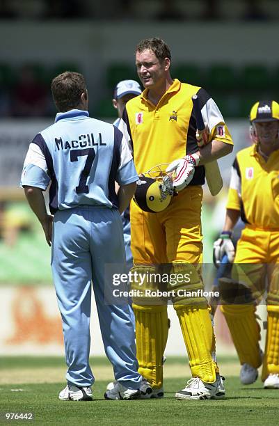 Tom Moody for the Western Warriors and Stuart MacGill for the NSW Blues discuss the umpires decision, as they await the third umpires verdict, during...