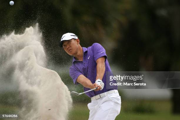 Anthony Kim hits out of the bunker on the 12th hole during round one of the 2010 WGC-CA Championship at the TPC Blue Monster at Doral on March 11,...