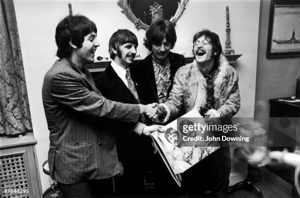 The Beatles George Harrison , Ringo Starr, John Lennon and Paul McCartney, hold the sleeve of their new LP, 'Sgt. Pepper's Lonely Hearts Club Band',...